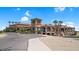Exterior of the clubhouse with lush grounds, mature palms, and inviting pathway at 3716 E Andre Ave, Gilbert, AZ 85298