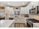Modern kitchen with stainless steel appliances, white cabinetry, and a functional island at 3716 E Andre Ave, Gilbert, AZ 85298