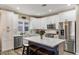 Bright kitchen featuring white cabinets, stainless steel appliances, and a center island with seating at 3716 E Andre Ave, Gilbert, AZ 85298