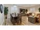 Cozy living room with wood floors, a dining area, and comfortable seating at 3716 E Andre Ave, Gilbert, AZ 85298