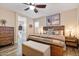 Farmhouse style main bedroom with hardwood floors, ceiling fan, a decorative bed and an ensuite bathroom at 3716 E Andre Ave, Gilbert, AZ 85298
