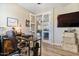 Home office with hardwood floors, desk and chair, and glass doors opening to living space at 3716 E Andre Ave, Gilbert, AZ 85298