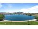 Scenic view of the large community pond with walking path, landscaping, and mountain views in the distance at 3716 E Andre Ave, Gilbert, AZ 85298
