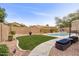 Backyard pool with lush landscaping, privacy fence, and lounge area at 3716 E Andre Ave, Gilbert, AZ 85298