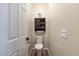Cozy powder room with hardwood floors, a toilet, and a cabinet at 3716 E Andre Ave, Gilbert, AZ 85298