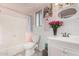 Pink themed bathroom with shower-tub combo, ample lighting, decorated vanity and stylish details at 3973 W Hearn Rd, Phoenix, AZ 85053