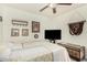 Comfortable bedroom featuring soft lighting, ceiling fan, and a warm, inviting atmosphere at 3973 W Hearn Rd, Phoenix, AZ 85053