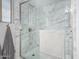 Beautiful glass-enclosed marble shower with a hand towel at 3973 W Hearn Rd, Phoenix, AZ 85053