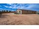 Spacious backyard with a partially completed patio area and ample potential for landscaping at 40433 W Hensley Way, Maricopa, AZ 85138