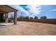 Spacious backyard with a covered patio area, perfect for entertaining and relaxing at 40433 W Hensley Way, Maricopa, AZ 85138