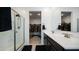 Bathroom featuring dual sinks, a glass-enclosed shower, and access to the walk-in closet at 40433 W Hensley Way, Maricopa, AZ 85138