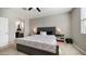 Comfortable bedroom features neutral walls, a ceiling fan, and an upholstered headboard at 40433 W Hensley Way, Maricopa, AZ 85138