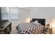 Cozy bedroom with a black cushioned headboard and patterned bedspread at 40433 W Hensley Way, Maricopa, AZ 85138