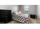 Bedroom features a queen bed, dresser, nightstand, and a large window at 40433 W Hensley Way, Maricopa, AZ 85138