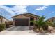Charming single-story home featuring a two-car garage and landscaped front yard at 40433 W Hensley Way, Maricopa, AZ 85138