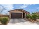 Well-maintained house showcasing its architectural style and curb appeal at 40433 W Hensley Way, Maricopa, AZ 85138