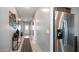 Spacious hallway featuring tile flooring, art decorations, and stainless steel refrigerator at 40433 W Hensley Way, Maricopa, AZ 85138
