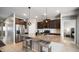 Stylish kitchen boasts a granite island with seating and stainless steel appliances at 40433 W Hensley Way, Maricopa, AZ 85138