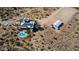 Overhead view of a desert home with a pool, solar panels, covered patios, and horse property at 40445 N 32Nd St, Cave Creek, AZ 85331