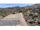 Aerial view of equestrian center including covered stalls and riding arena in desert setting at 40445 N 32Nd St, Cave Creek, AZ 85331