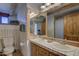 Charming bathroom featuring double sinks, ample counter space, and rustic wood accents adding warmth at 40445 N 32Nd St, Cave Creek, AZ 85331