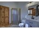 Cozy bathroom featuring wood door, corner shower, vanity and tile flooring at 40445 N 32Nd St, Cave Creek, AZ 85331