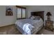 Inviting bedroom with a dark wood headboard, soft lighting, and a serene view outside the window at 40445 N 32Nd St, Cave Creek, AZ 85331