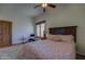Comfortable bedroom with natural light, a patterned bedspread, and a rustic wood door at 40445 N 32Nd St, Cave Creek, AZ 85331