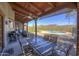 Spacious covered patio with outdoor dining and cooking areas overlooking pool and desert landscape at 40445 N 32Nd St, Cave Creek, AZ 85331
