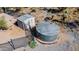 Aerial view of water storage tank and metal shed behind a black fence on a desert property at 40445 N 32Nd St, Cave Creek, AZ 85331