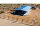 Aerial view of a horse property showing a covered shelter and riding arena in a desert setting at 40445 N 32Nd St, Cave Creek, AZ 85331