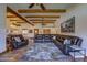 Spacious living area featuring wooden beams, Saltillo tile, and a large leather sectional couch at 40445 N 32Nd St, Cave Creek, AZ 85331