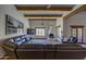 Expansive living room with exposed beams, fireplace, and leather sectional with Saltillo tile flooring at 40445 N 32Nd St, Cave Creek, AZ 85331