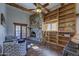 Cozy living room with a stone fireplace, built in wood shelves and ample seating at 40445 N 32Nd St, Cave Creek, AZ 85331