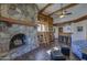 Comfortable living room featuring a stone fireplace, bookshelves, and cozy seating at 40445 N 32Nd St, Cave Creek, AZ 85331