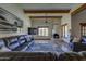 Spacious living room featuring beamed ceilings, a fireplace, comfortable seating, and scenic views at 40445 N 32Nd St, Cave Creek, AZ 85331