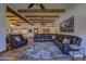 Comfortable living room with exposed beams, leather seating, and Saltillo tile flooring at 40445 N 32Nd St, Cave Creek, AZ 85331