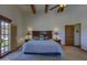 Serene main bedroom with a king bed, beamed ceilings and access to a backyard pool at 40445 N 32Nd St, Cave Creek, AZ 85331