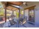 Outdoor dining area with a rustic fireplace and ceiling fan for ultimate outdoor living at 40445 N 32Nd St, Cave Creek, AZ 85331