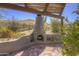 Cozy outdoor fireplace with rustic pergola, perfect for relaxing and enjoying the desert landscape at 40445 N 32Nd St, Cave Creek, AZ 85331