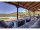 Inviting covered patio with comfortable seating, a fire pit, and pool views at 40445 N 32Nd St, Cave Creek, AZ 85331