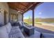 Charming covered patio with a fireplace, desert views, and comfortable lounge seating at 40445 N 32Nd St, Cave Creek, AZ 85331