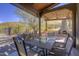 Inviting outdoor patio with dining table, chairs, and outdoor fireplace overlooking scenic views at 40445 N 32Nd St, Cave Creek, AZ 85331