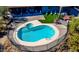 An aerial view of the sparkling pool, lush greenery, and outdoor seating area at 40445 N 32Nd St, Cave Creek, AZ 85331