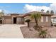 Beautiful home with a well-maintained yard, palm trees, stone accents, and a spacious driveway at 4159 E Shannon St, Gilbert, AZ 85295