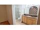Bathroom with double sinks, framed mirrors, and a tiled shower at 4547 W Villa Theresa Dr, Glendale, AZ 85308