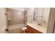 Bathroom featuring a bathtub with shower, vanity sink, and tiled flooring at 4547 W Villa Theres Dr, Glendale, AZ 85308