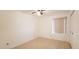 Bedroom with a window, white ceiling fan, tile flooring, and white walls at 4547 W Villa Theresa Dr, Glendale, AZ 85308