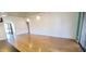 Bright, airy living area featuring wood flooring, neutral walls, and natural light from a sliding glass door at 4547 W Villa Theresa Dr, Glendale, AZ 85308
