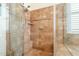 Tile shower features a built-in bench and glass doors at 4709 E Blue Spruce Ln, Gilbert, AZ 85298